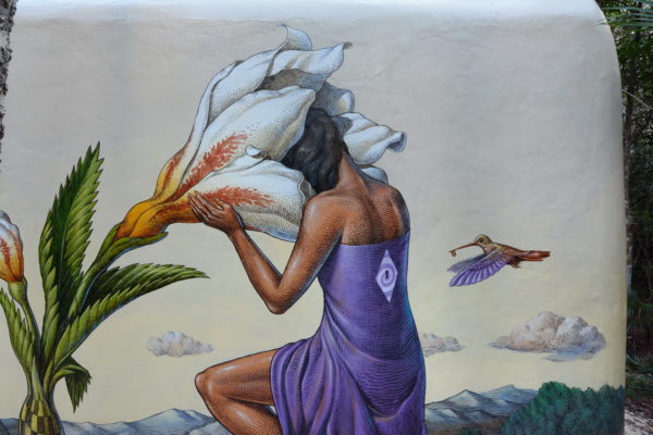 Detail of the original Time Gate mural showing a figure with a white flower and hummingbird