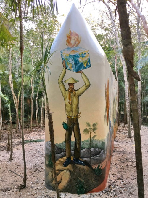 Tall original Time Gate structure painted with a figure holding a blue cube